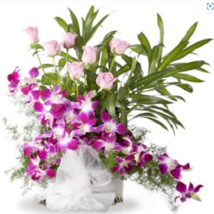 Arrangement of orchids and pink roses